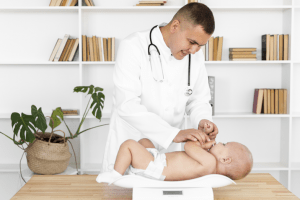 smiling-doctor-weighing-little-baby