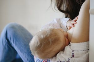 mother-is-breastfeeding-little-blond-baby